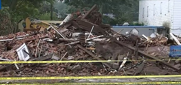 A historic but unoccupied building in Meriden was torn down Wednesday night following a partial collapse.