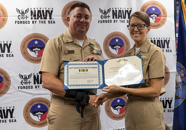Photo By Edward Jones | JOINT BASE SAN ANTONIO-FORT SAM HOUSTON – (August 3, 2022) Chief Fire Controlman Christopher R. Johnson from Deer Park, Texas, poses with his Navy and Marine Corps Achievement award and NTAG San Antonio Commanding Officer, CDR. Stephanie Simoni.
