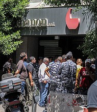 Security forces gather outside a "Federal Bank" branch in Beirut on August 11.
Mandatory Credit:	Anwar Amro/AFP via Getty Images