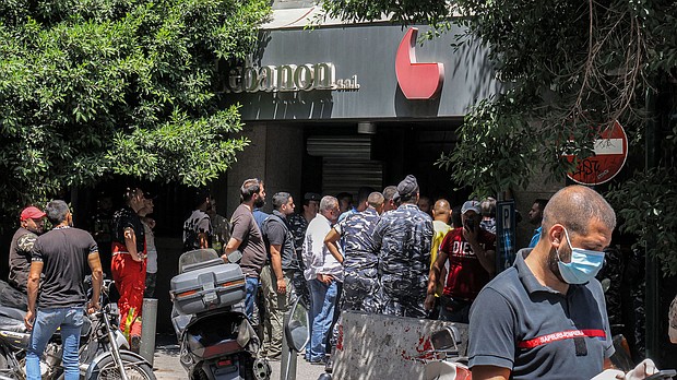 Security forces gather outside a "Federal Bank" branch in Beirut on August 11.
Mandatory Credit:	Anwar Amro/AFP via Getty Images