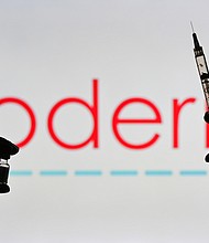 This illustrative image showsna person holding a medical syringe and a Covid-19 vaccine vial in front of the Moderna logo on January 12, 2021, in Edmonton, Alberta, Canada.
Mandatory Credit:	 Artur Widak/NurPhoto/Getty Images/FILE