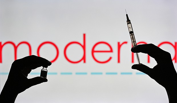 This illustrative image showsna person holding a medical syringe and a Covid-19 vaccine vial in front of the Moderna logo on January 12, 2021, in Edmonton, Alberta, Canada.
Mandatory Credit:	 Artur Widak/NurPhoto/Getty Images/FILE