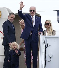 President Joe Biden, waves as he is joined by, from left, son Hunter Biden, grandson Beau Biden, first lady Jill Biden, and daughter-in-law Melissa Cohen, at the top of the steps of Air Force One at Andrews Air Force Base, Maryland, August 10. The Biden family are heading to South Carolina for a week-long vacation on Kiawah Island.
Mandatory Credit:	Susan Walsh/AP