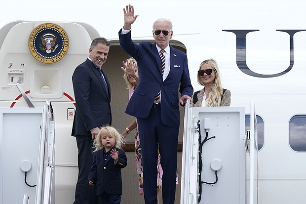 President Joe Biden, waves as he is joined by, from left, son Hunter Biden, grandson Beau Biden, first lady Jill Biden, and daughter-in-law Melissa Cohen, at the top of the steps of Air Force One at Andrews Air Force Base, Maryland, August 10. The Biden family are heading to South Carolina for a week-long vacation on Kiawah Island.
Mandatory Credit:	Susan Walsh/AP