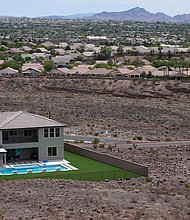 The Democrats' climate bill offers $4 billion to Western states for drought relief. A home with a pool abuts the desert on the edge of the Las Vegas valley in Henderson, Nevada.
Mandatory Credit:	John Locher/AP