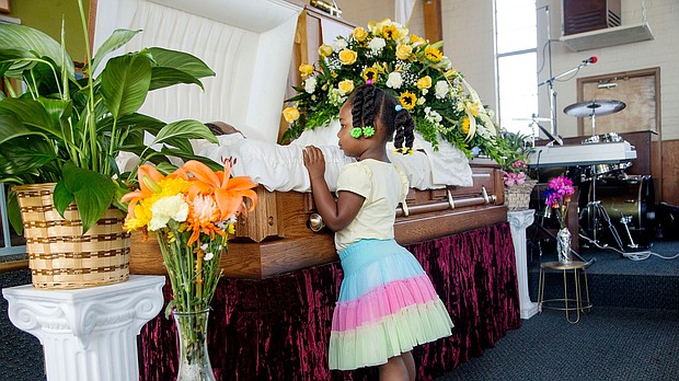 Michelle Cusseaux's 3-year-old niece looks in her casket during funeral services in 2014.
Mandatory Credit:	Nick Oza/The Arizona Republic/AP