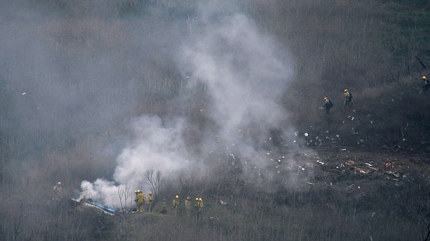 LA county firefighters on the scene of a helicopter crash that reportedly killed Kobe Bryant in Calabasas, California, U.S., January 26, 2020.     Photos taken at the scene of the fatal helicopter crash that killed the NBA legend, his daughter and seven others were shared by a Los Angeles County firefighter during the cocktail hour at an awards ceremony a month after the crash, according to witness testimony.
Mandatory Credit:	Gene Blevins/Reuters