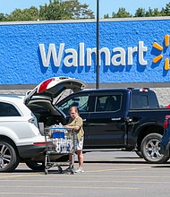 On August 16, Walmart offered a much rosier picture for consumer spending than it had forecast just a month earlier, as the company's steep discounts led customers to shop more. A woman loads groceries into her car at a Walmart in Pennsylvania on August 12.
Mandatory Credit: Photo by Paul Weaver/SOPA Images/LightRocket/Getty Images