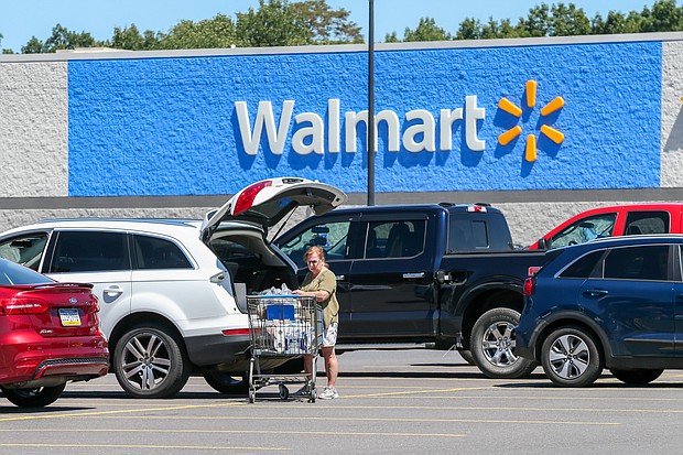 On August 16, Walmart offered a much rosier picture for consumer spending than it had forecast just a month earlier, as the company's steep discounts led customers to shop more. A woman loads groceries into her car at a Walmart in Pennsylvania on August 12.
Mandatory Credit:	Photo by Paul Weaver/SOPA Images/LightRocket/Getty Images