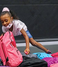Zayla Braxton, 6, selects a backpack full of school supplies during the Northside Coalition for Children’s annual Back-to-School Rally on Aug. 13 at Liberation Church on Midlothian Turnpike.