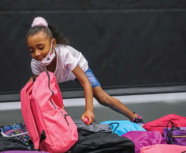 Zayla Braxton, 6, selects a backpack full of school supplies during the Northside Coalition for Children’s annual Back-to-School Rally on Aug. 13 at Liberation Church on Midlothian Turnpike.