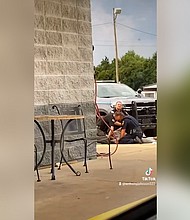 Three law enforcement officers in Crawford County, Arkansas, have been placed on leave after a video shared on social media shows them beating and restraining a man in a parking lot.
Mandatory Credit:	Courtesy NaomiRHelm