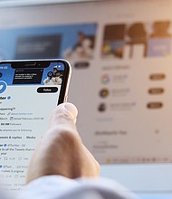 A person is shown using Twitter.
Mandatory Credit:	Adobe Stock