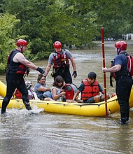 Members of the Balch Springs Fire Department bring a family of four to higher ground after rescuing them from their home in Balch Springs, Texas, on August 22.
Mandatory Credit:	Elías Valverde II/Associated Press