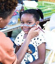 Skylar Branch, 7, is all smiles while having her face painted at the children’s craft table during the Elegba Folklore Society’s 31st Annual Down Home Family Reunion on Saturday, Aug. 20, in Abner Clay Park.