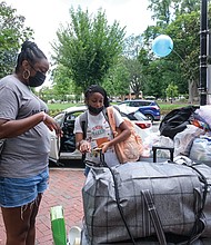 VCU freshman Laiana Trotter of Baltimore got help from her mom, Monique Totter, while moving into Gladding Resident Center. Ms. Trotter will major in pre-nursing. Nearly 4,200 first-year students have started classes at VCU for the fall semester.