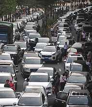 A Chinese island plans to ban the sales of fossil fuel-powered vehicles by 2030.
Mandatory Credit:	Wang Di/Imaginechina/AP