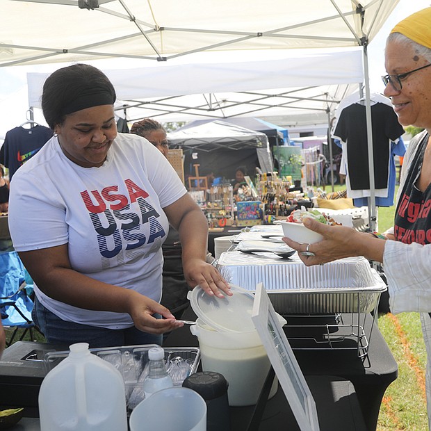 Ana Edwards, right, of Richmond samples culinary delights from Minty’s Catering during the 19th annual Happily Natural Festival + Garden EXPO on Richmond’s South Side on Aug. 27.