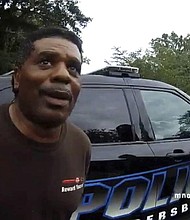 This image captured from bodycam video released by the Childersburg (Ala.) Police Department and provided by attorney Harry Daniels shows Michael Jennings, left, in custody in Childersburg, Ala., on Sunday, May 22, 2022. Jennings was helping out a friend by watering flowers when officers showed up and placed him under arrest within moments. (Childersburg Police Department via AP)