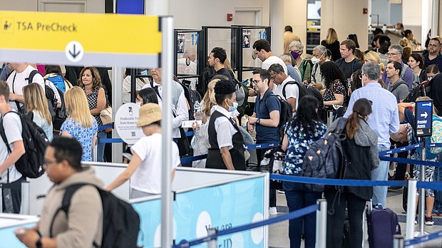 Travelers line up to enter a security checkpoint at Newark Liberty International Airport on July 1.
Mandatory Credit: Jeenah Moon/Getty Images