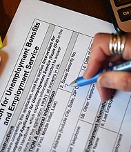 Weekly jobless claims fell to the lowest level since late June as employers appear reluctant to part with workers in a tight labor market. A person files an application for unemployment benefits in April of 2020, in Arlington, Virginia.
Mandatory Credit:	OLIVIER DOULIERY/AFP/AFP via Getty Images