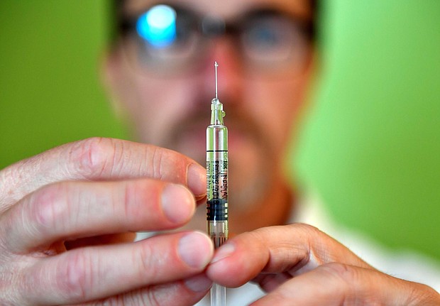 A pharmacist handles a syringe for the flu vaccine in October of 2017 in France.
Mandatory Credit:	Georges Gobet/AFP/AFP via Getty Images