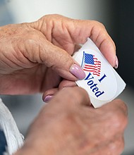 A poll worker holds a sticker that reads, I Voted on May 17 in Mt. Gilead, North Carolina. Voting for this year's general election kicked off with North Carolina becoming the first state to begin sending out absentee ballots.
Mandatory Credit:	Sean Rayford/Getty Images