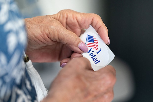 A poll worker holds a sticker that reads, I Voted on May 17 in Mt. Gilead, North Carolina. Voting for this year's general election kicked off with North Carolina becoming the first state to begin sending out absentee ballots.
Mandatory Credit:	Sean Rayford/Getty Images