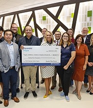 (front row, left to right) Vanessa Perez, corporate social responsibility, Hyundai Motor America, Andy Chen, engineer, vehicle safety investigations, Hyundai North American Safety Office, Brandon Ramirez, director, corporate social responsibility, Hyundai Motor America, Heather Newsome, assistant chief nursing officer, Children’s Hospital of Savannah, Jenna Morris, SafeKids coordinator, Children’s Hospital of Savannah, Kristen King, child life manager, Children’s Hospital of Savannah, Laura Dow, chief financial officer, Memorial Health; (back row, left to right) Terrance Ross, Hyundai of Savannah, Shelly Harrell, vice president, business development, Memorial Health, Chris Schimek, general manager, Hyundai of Savannah, Todd Isbell, chief nursing officer, Memorial Health, David Hoffenberg, chief operating officer, Memorial Health, Katie Van Hook, assistant chief nursing officer, Memorial Health, Les Fussell, Richmond Hill City Counsel, Chief Brendon Greene, Richmond Hill Fire Department at Dwaine & Cynthia Willett Children's Hospital Of Savannah in Savannah, Ga. on September 9, 2022. (Photo/Hyundai)