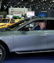 President Joe Biden driving GM vehicle at 2022 Detroit Auto Show