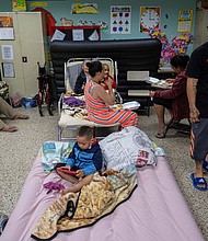 People evacuated from their homes take refuge in the classroom of a public school in Guayanilla, Puerto Rico, on September 18.
Mandatory Credit:	Ricardo Arduengo/Reuters