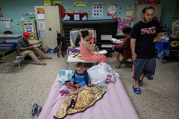 People evacuated from their homes take refuge in the classroom of a public school in Guayanilla, Puerto Rico, on September 18.
Mandatory Credit:	Ricardo Arduengo/Reuters