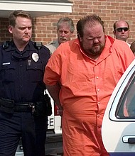 Officials escort murder suspect Alan Eugene Miller, right, in 1999 from the Pelham City Jail in Alabama.
Mandatory Credit:	Dave Martin/AP/File