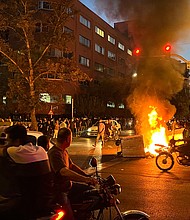 Five people have been killed by Iranian security forces during protests that were sparked by the death of Mahsa Amini. Demonstrators are pictured here gathering around a burning barricade during a protest for Amini.
Mandatory Credit:	AFP/Getty Images