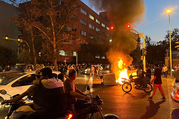 Five people have been killed by Iranian security forces during protests that were sparked by the death of Mahsa Amini. Demonstrators are pictured here gathering around a burning barricade during a protest for Amini.
Mandatory Credit: AFP/Getty Images