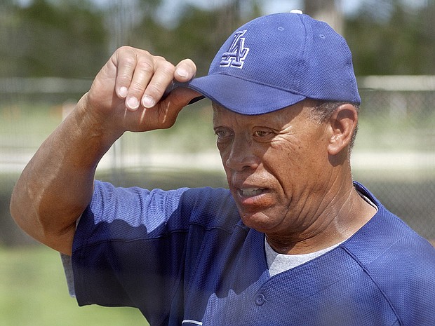 Los Angeles Dodgers bunting and base running coordinator Maury Wills adjusts his cap during spring training at Dodgertown in Vero Beach, Fla. Wills remembered back 43 years ago to that April night when he became the first batter to hit on artificial turf in a major league game. Even when the green rug was novel, he didn't like it.
Mandatory Credit:	RICHARD DREW/ASSOCIATED PRESS