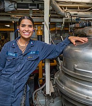 220810-N-NY362-2006 PHILIPPINE SEA (Sept 10, 2022) Gas Turbines Systems Technician (Mechanical) 3rd Class Sierra Gustavus, from Baytown, Texas, poses for a photograph next to a fuel oil lamp aboard Ticonderoga guided-missile cruiser USS Antietam (CG 54). The Antietam fuel team obtains, inspects, and delivers F76 fuel samples for the ship. (U.S. Navy Photo by Mass Communication Specialist 3rd Class Santiago Navarro)