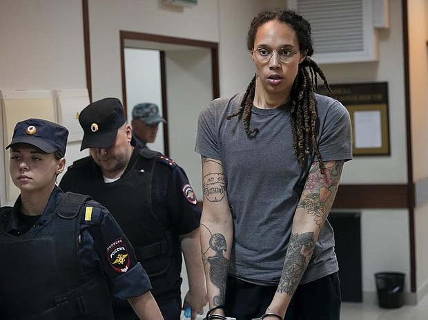 WNBA star and two-time Olympic gold medalist Brittney Griner is escorted from a courtroom after a hearing(AP Photo/Alexander Zemlianichenko)
