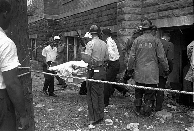 Firemen and ambulance attendants remove a covered body from the 16th Street Baptist Church, where an explosion ripped the structure during services, killing four black girls, on Sept. 15, 1963. Sarah Collins Rudolph lost an eye and has pieces of glass inside her body from a Ku Klux Klan bombing that killed her sister and three other young girls inside an Alabama church 59 years ago.