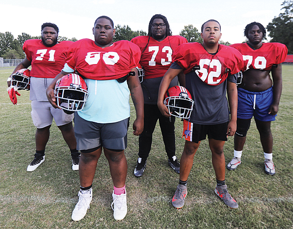 Thomas Jefferson High School Vikings’ offensive line pause for a portrait during a Sept. 14 practice on their home field. They are from left: Jaden Goodwin, senior; Cory Winston, senior; Zavier Artis, sophomore; Deon Wright, sophomore; and Zyan Hill, sophomore. Missing from the Viking lineup, Timarion “T-Rex” Venable, a junior.