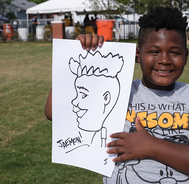 Jamon Bonaparte, 9, displays a drawing of himself by JT the Cartoonist, a Church Hill artist. Along with visual art, performing arts and music were part of the family-friendly RVA East End Festival on Sept 24. Since 2016, the festival has raised more than $400,000 to support creative and performing arts at eight Richmond Public Schools located in the East End. Bravo!