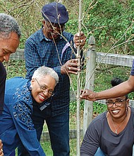 Members of Branch’s Baptist Church help plant a tree on the church property in 2018.