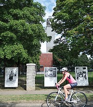 A look back at the summer of 2022 includes a cyclist riding past Black Lives Matter photographs at Virginia Union University, 1500 N. Lombardy St.