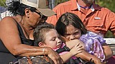 Yolanda Rios, left, holds her grandchildren, Ava, 7, and Giovanni, 5, as they are evacuated Monday by airboat through floodwaters along the Peace River to get to a hospital for medical care, in the aftermath of Hurricane Ian in Arcadia, Fla. The devastation from Hurricane Ian has left schools shuttered indefinitely in parts of Florida, leaving storm-weary families anxious for word on when and how children can get back to classrooms.