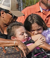 Yolanda Rios, left, holds her grandchildren, Ava, 7, and Giovanni, 5, as they are evacuated Monday by airboat through floodwaters along the Peace River to get to a hospital for medical care, in the aftermath of Hurricane Ian in Arcadia, Fla. The devastation from Hurricane Ian has left schools shuttered indefinitely in parts of Florida, leaving storm-weary families anxious for word on when and how children can get back to classrooms.