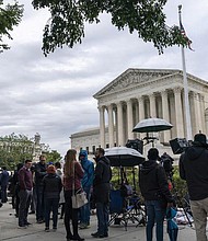 People gather as the Supreme Court begins its new term and to hear the first arguments Monday on Capitol Hill in Washington, . This session also was the first time that Justice Ketanji Brown Jackson participated as the court’s first Black woman justice. And it was the first time the public was able to attend since the court closed in March 2020 because of the coronavirus pandemic.