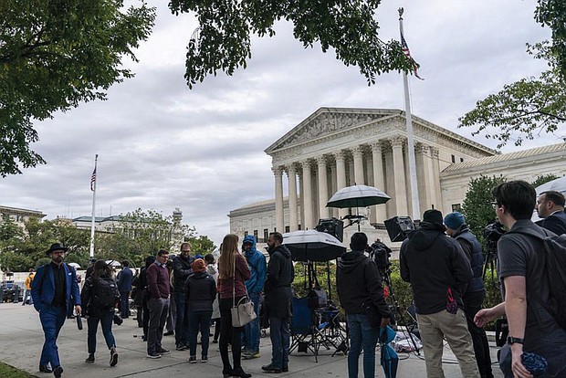 People gather as the Supreme Court begins its new term and to hear the first arguments Monday on Capitol Hill in Washington, . This session also was the first time that Justice Ketanji Brown Jackson participated as the court’s first Black woman justice. And it was the first time the public was able to attend since the court closed in March 2020 because of the coronavirus pandemic.