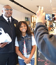 On “National Coffee with a Cop Day,” Richmond Police Chief Gerald M. Smith stopped by Starbucks Coffee at 2309 W. Broad St. and chatted with community members including 10-year-old Bella Brownlee, a 6th-grader at Albert Hill Middle School. Along with her mom, Lynne Brownlee, both of North Side, Bella made a cake for the chief, which they gave to him together. Bella, an accomplished singer also belted out a few stanzas of The Wiz’s “Ease on Down The Road” for the chief and others in the Starbucks. Bella is out of school today because Richmond Public Schools is closed for Yom Kippur. Her mother captures the moment here on her cell phone.