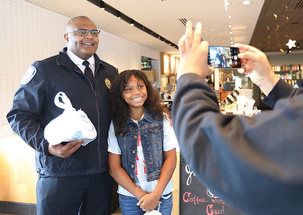 On “National Coffee with a Cop Day,” Richmond Police Chief Gerald M. Smith stopped by Starbucks Coffee at 2309 W. Broad St. and chatted with community members including 10-year-old Bella Brownlee, a 6th-grader at Albert Hill Middle School. Along with her mom, Lynne Brownlee, both of North Side, Bella made a cake for the chief, which they gave to him together. Bella, an accomplished singer also belted out a few stanzas of The Wiz’s “Ease on Down The Road” for the chief and others in the Starbucks. Bella is out of school today because Richmond Public Schools is closed for Yom Kippur. Her mother captures the moment here on her cell phone.