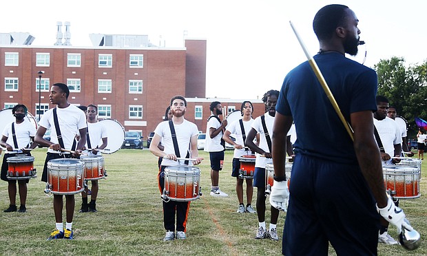 Members of Virginia State University’s Marching Band practice music and high-stepping routines that they will showcase during the school’s homecoming game this weekend. Taylor Whitehead is the interim band director for Virginia State University’s 120-member marching band, known as “The Trojan Explosion.” Drum major Juwan L. Walton, a junior from Franklin, keeps a trained eye on his fellow bandmates.